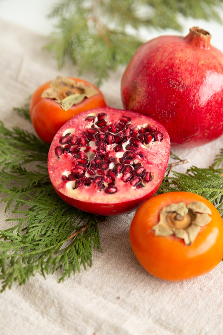 Holiday Cheese Board with pomegranates and persimmons 