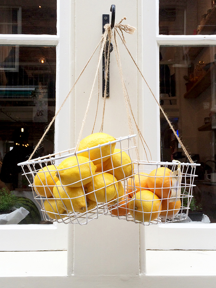 Love this storefront display of lemons in a basket