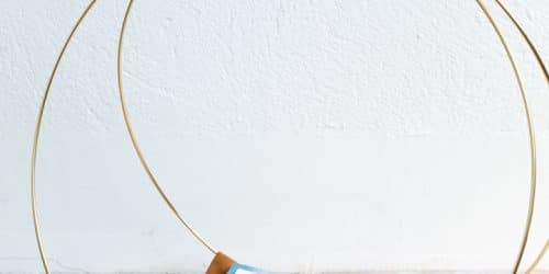 DIY magazine Rack using gold macrame hoops and leather