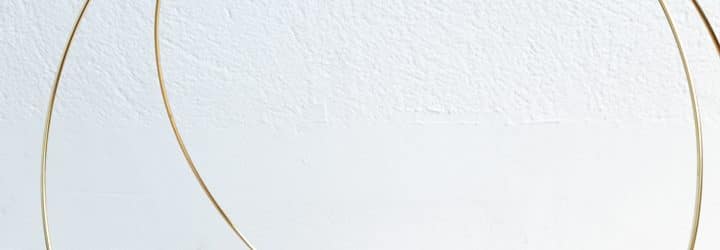 DIY magazine Rack using gold macrame hoops and leather