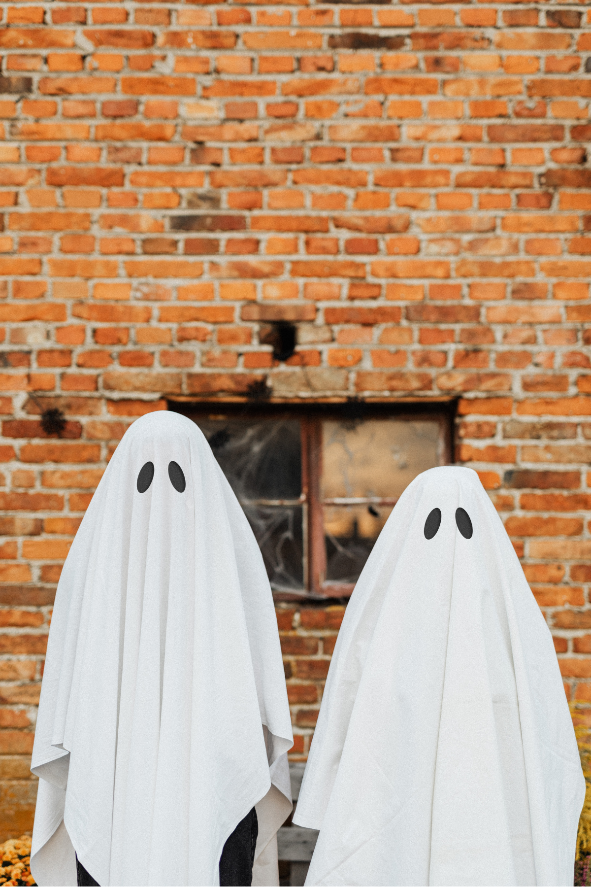 ghosts in front of brick wall